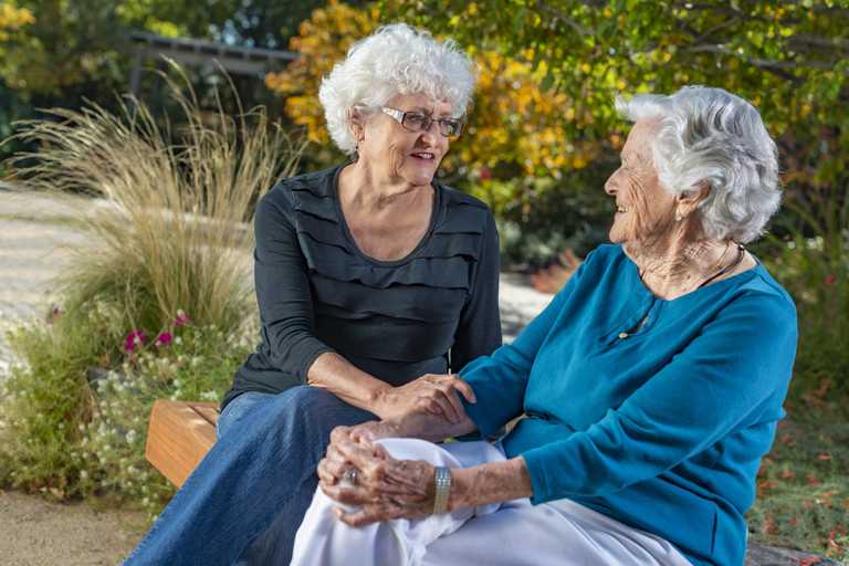 Two women discussing the Caregiver Support Initiative