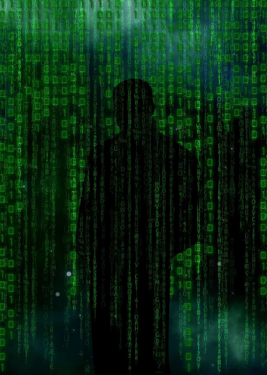 Illustration of a cyber criminal's silhouette masked behind a stream of 1s and 0s