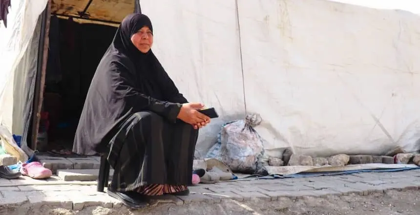 woman sits outside tent in Turkey