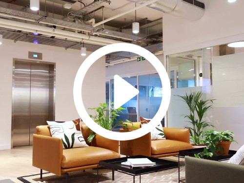 Stylish shared workspace with exposed ceiling above modern design brown and grey leather style armchairs Skype background