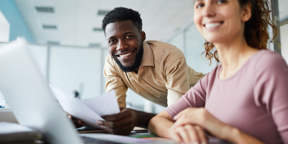 What are the four main types of data analysis? Two data analysts smiling at the camera Two data analysts smiling at the camera, holding some documents