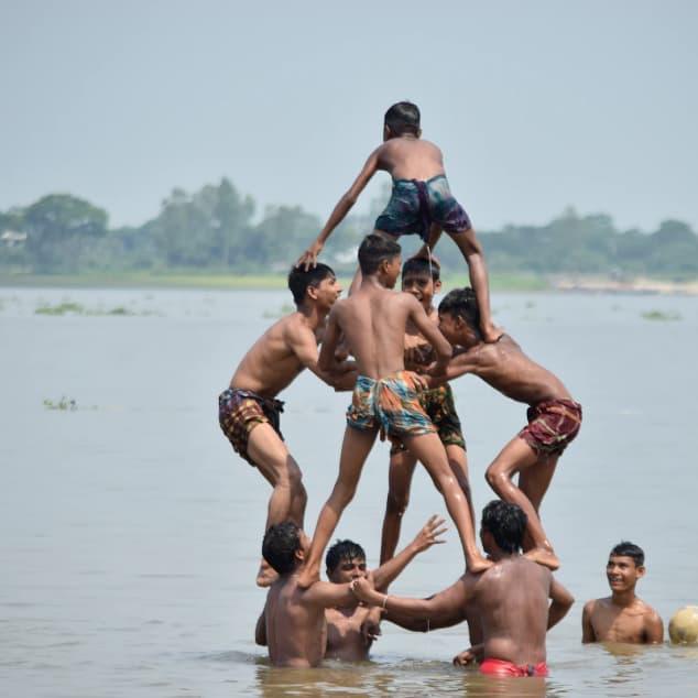 Young Bangladeshi boys playing contaminated water body.
