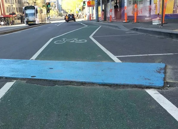 Road plate over bike lane