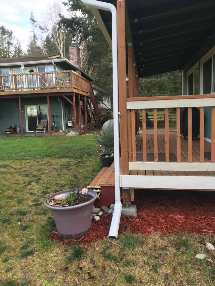 different angle of new gutter installation on green home