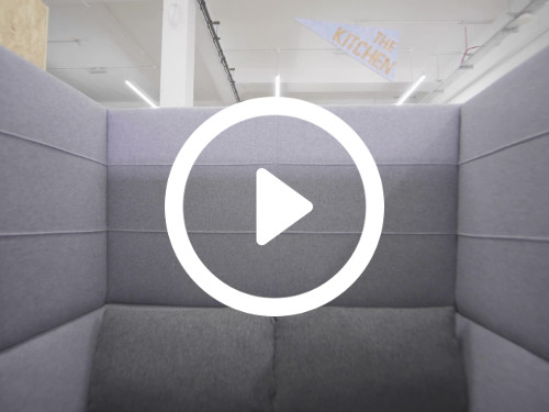 Private meeting booth cubicle with grey padded sofa and upholstery  Microsoft Teams background