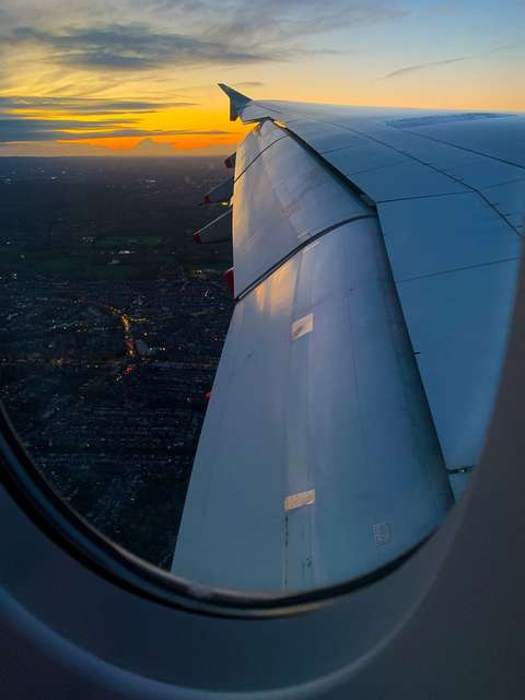 Sunrise view over the wing of the plane on approach to London Heathrow.
