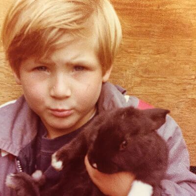 Toby Briggs as a young kid holding a rabbit