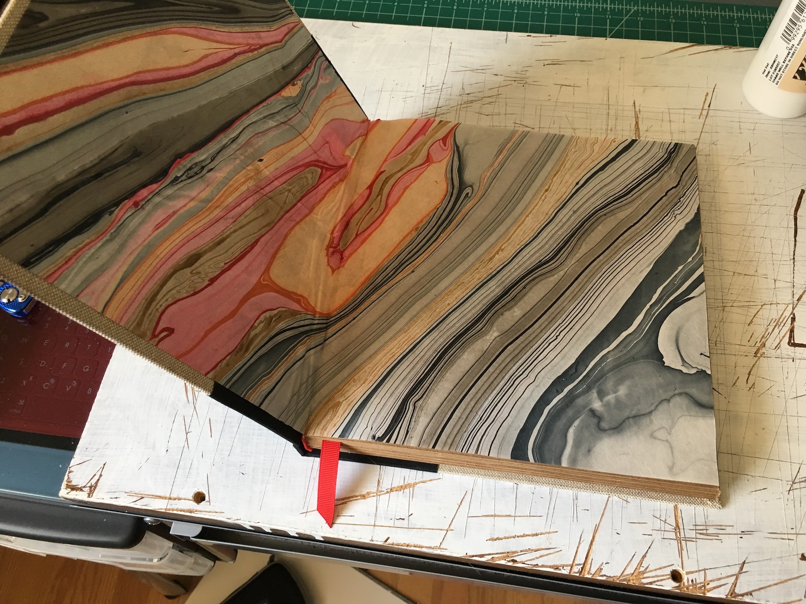 <p>The endpapers, glued in place. Unfortunately that paper is pretty thin so it wrinkled when I brushed on the glue, even though I tried really hard to use the glue really sparingly. Oh well.</p>\n