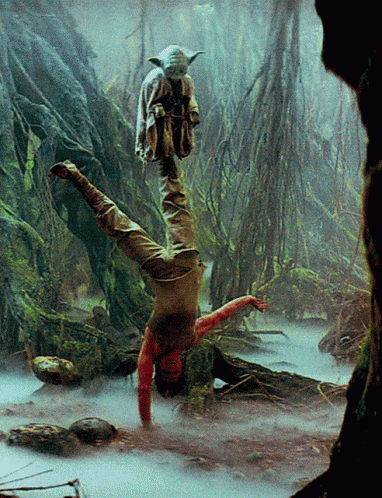 Luke Skywalker balancing on one hand with Yoda standing on his upraised foot