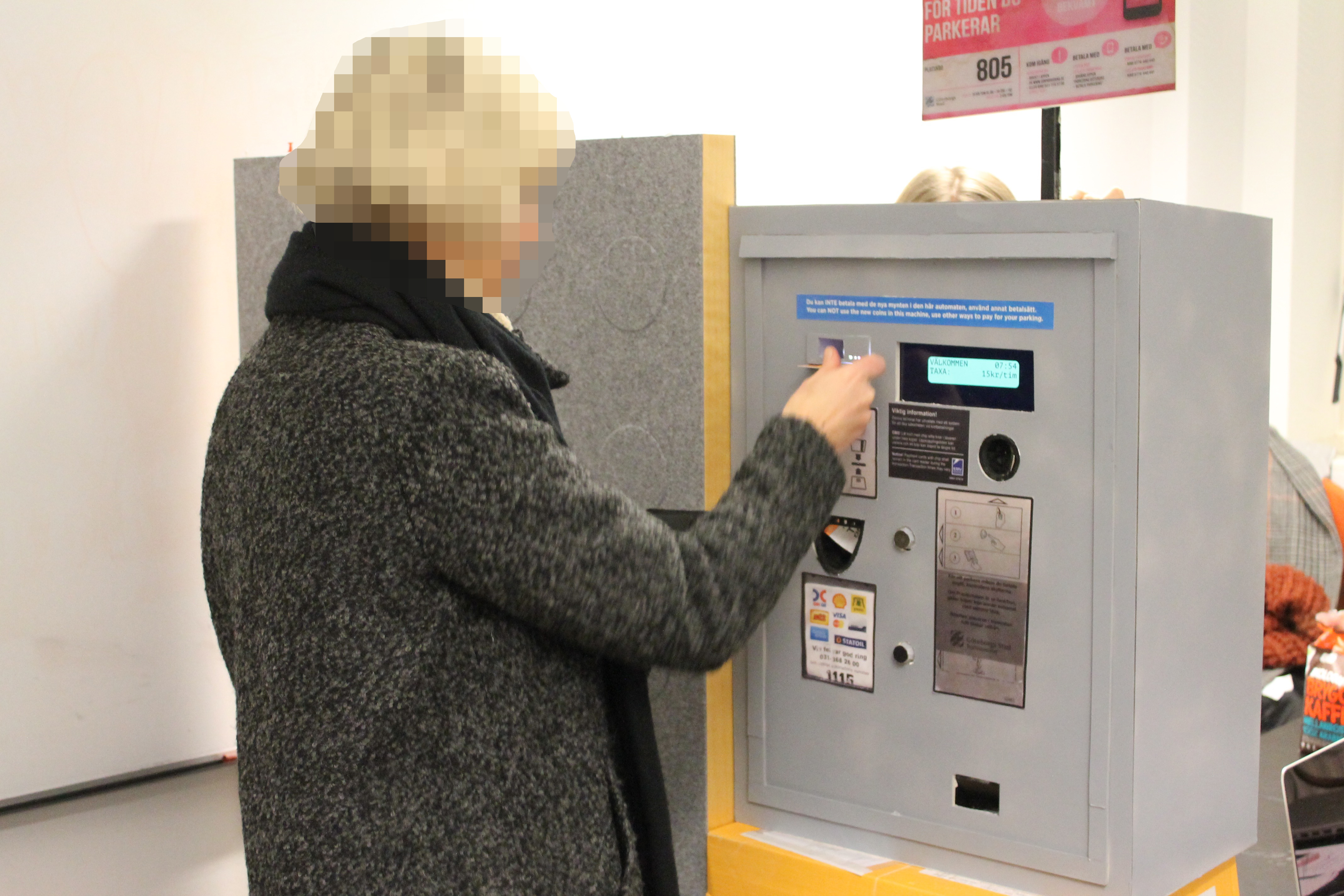 A woman participating in a user test doing tasks at the parking meter