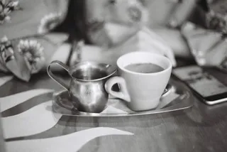 A long black with water on the side(black and white)
