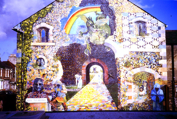 fantastical wall mural on gable end of terraced houses featuring a rainbow and a dragon