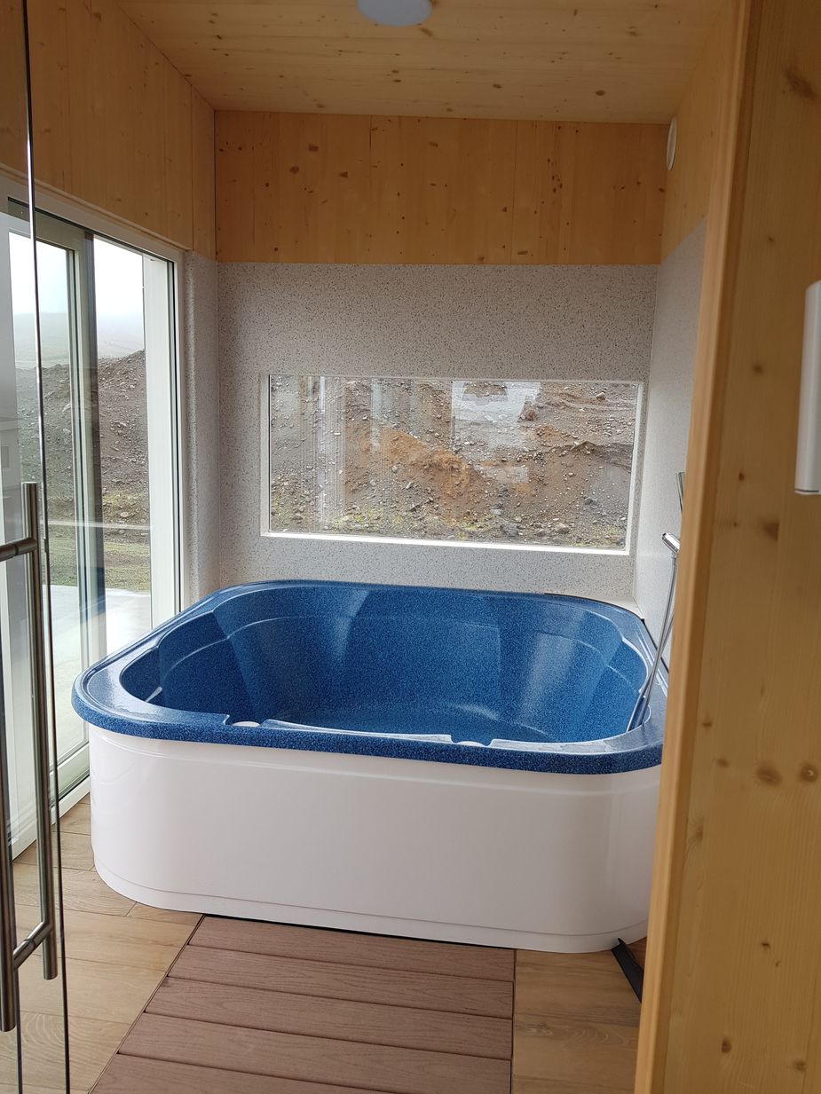 The hot tub is inside but with a big glass door that you can open