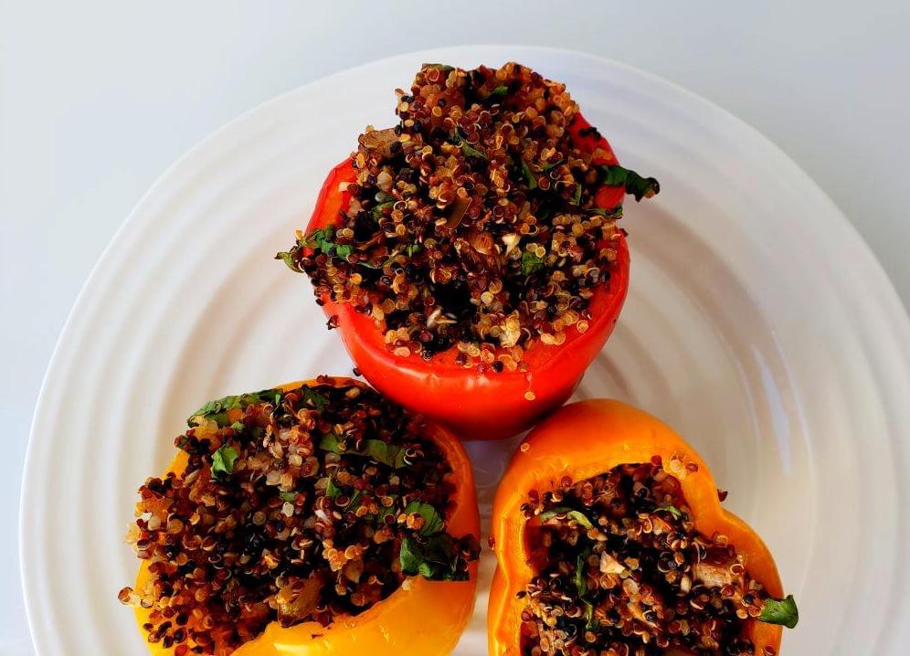 Plate of three quinoa and mushroom stuffed peppers
