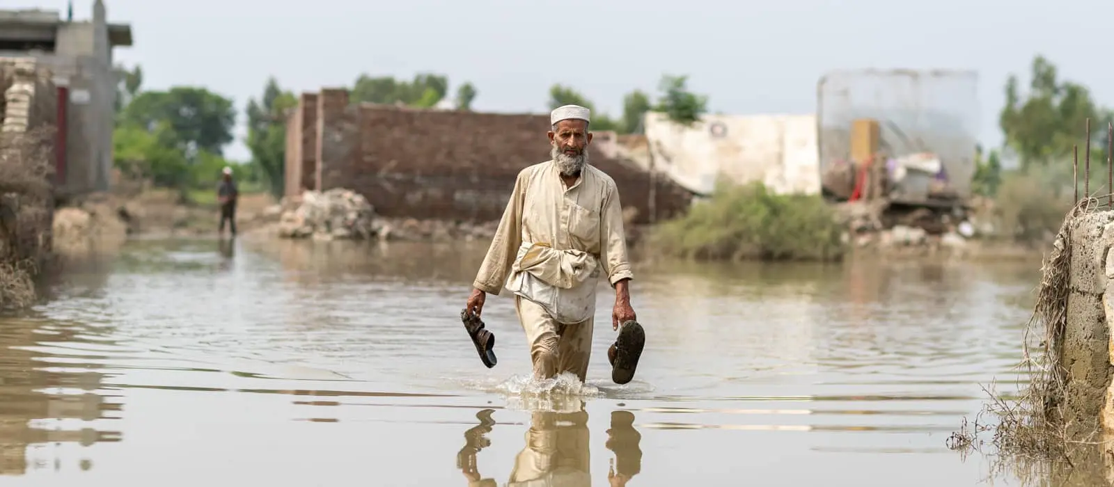 Man standing in flooding in the Nowshera District, Khyber Pakhtunkhwa