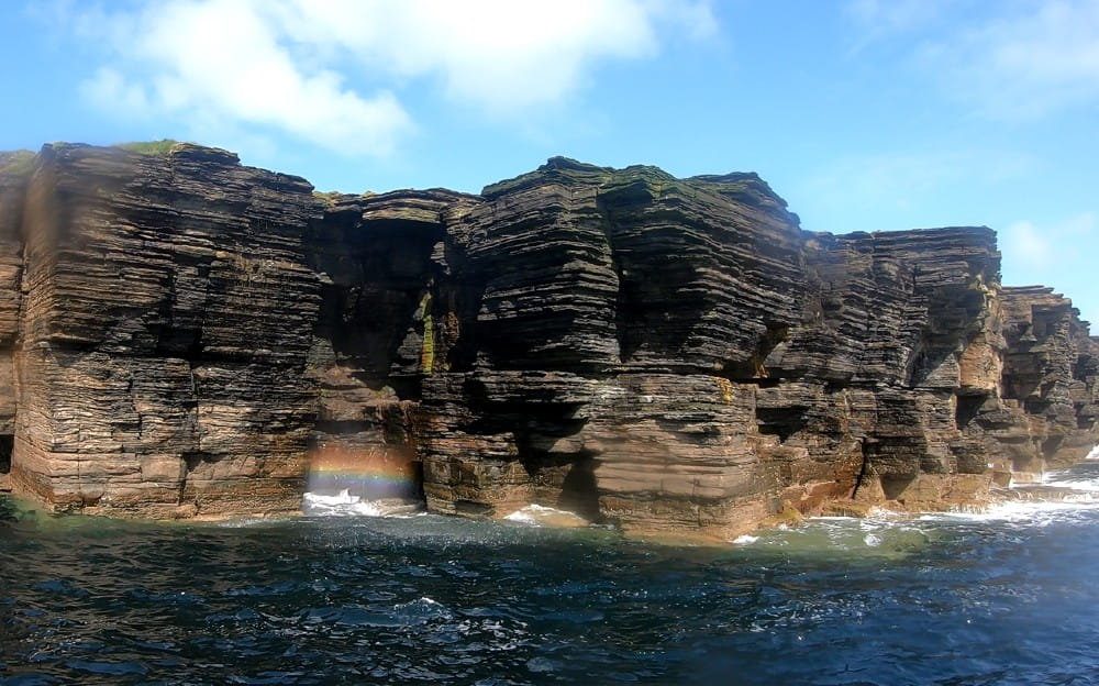 The dramatic gouged and eroded sandstone cliffs of Shapinsay
