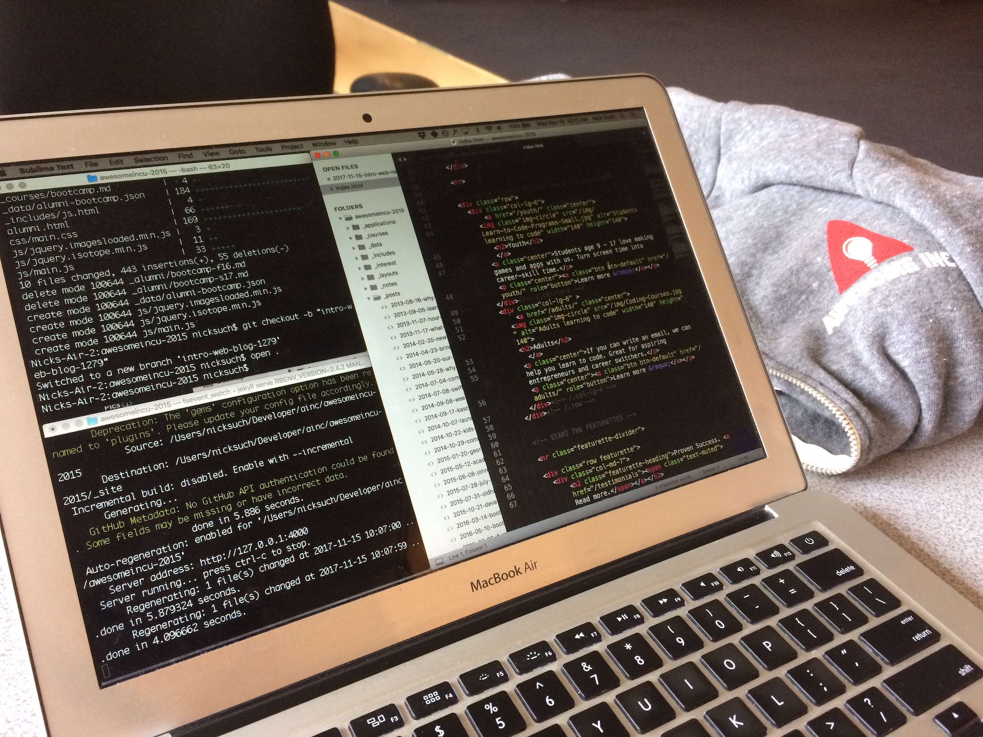 Laptop with terminal and text editor with HTML code