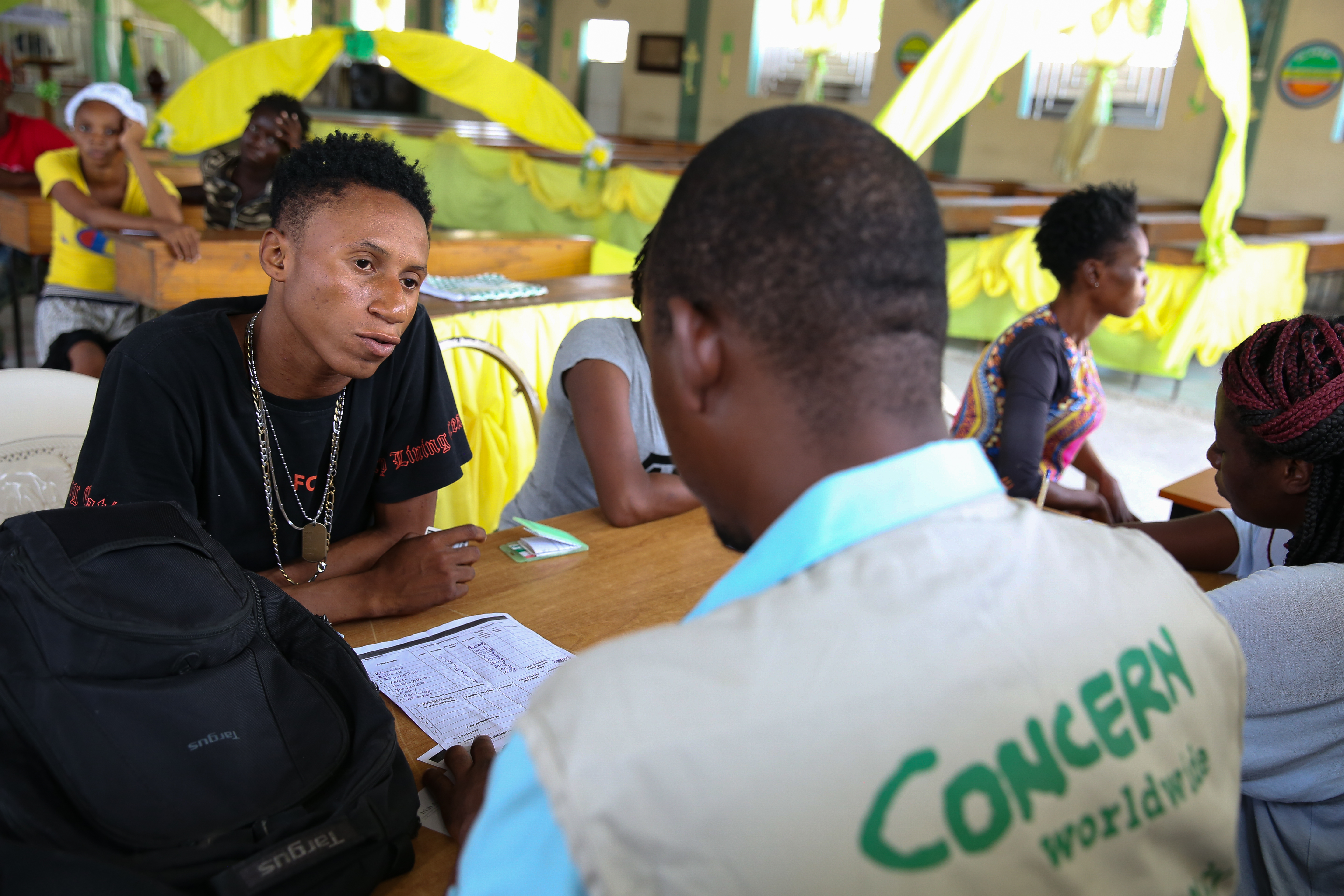 A young man from Cité Soleil, Port au Prince, sits at a training and mentoring session for people taking part in Concern’s Urban Integrated Program in Haiti