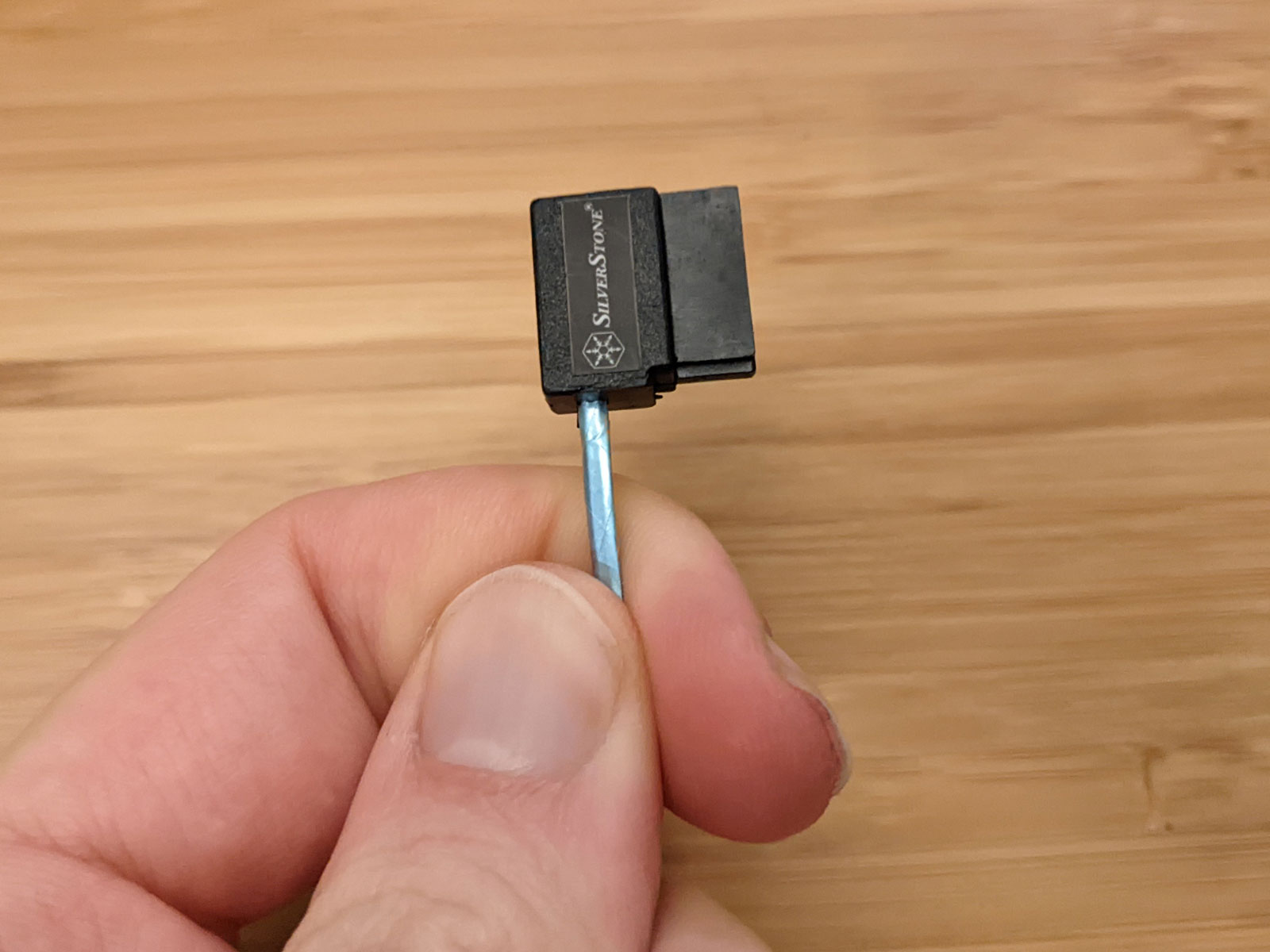 Me holding 90-degree SATA cable
