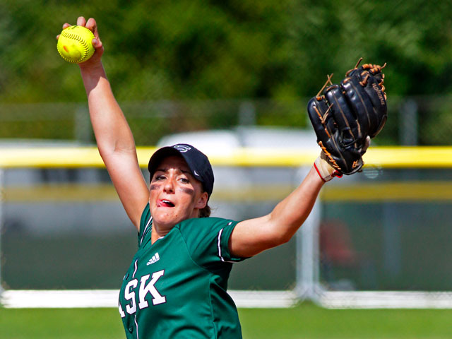 A college softball pitcher in a windup