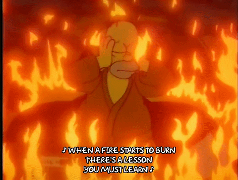 Homer Simpson standing in a burning room