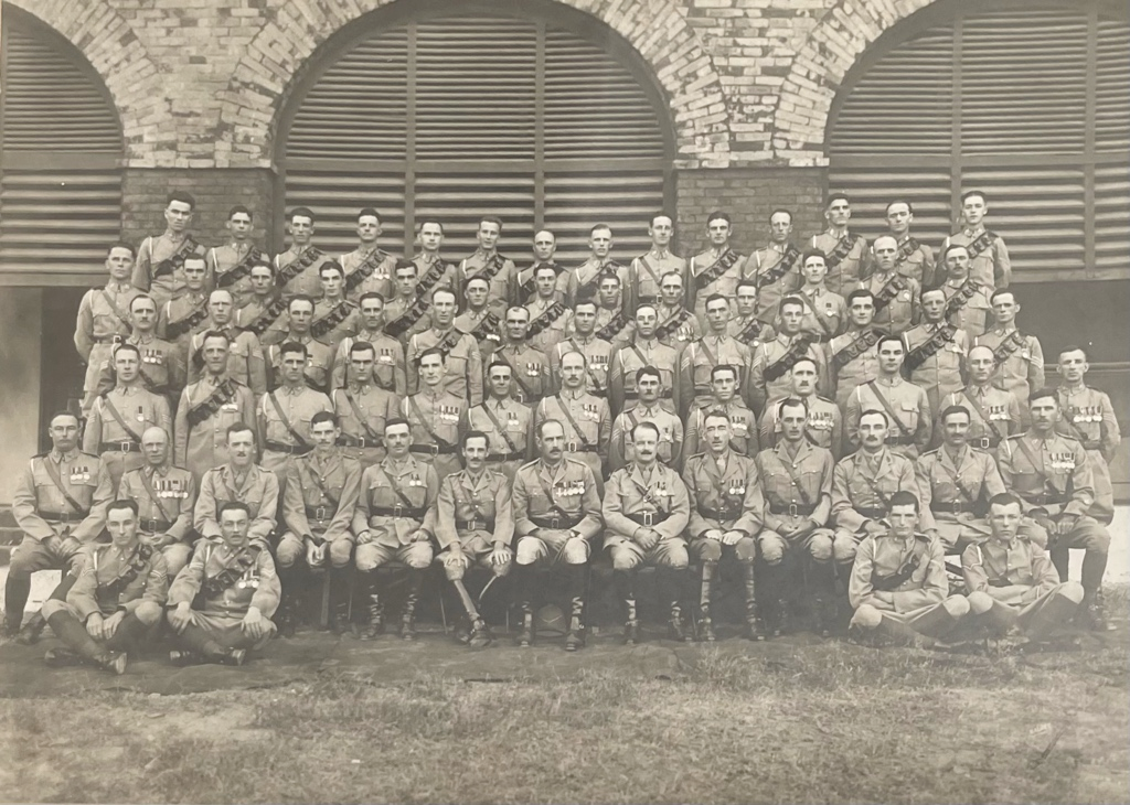 A black and white picture of seventy captains in the British army sitting for a photograph in India, 1934