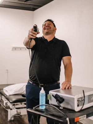 Adam Giesbrecht, Integral founder, laughing while playing with a shockwave therapy gun