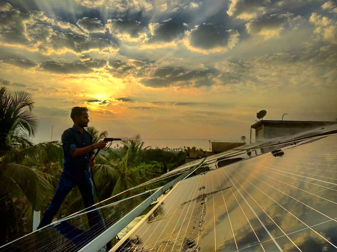 solar panels being cleaned, Mumbai