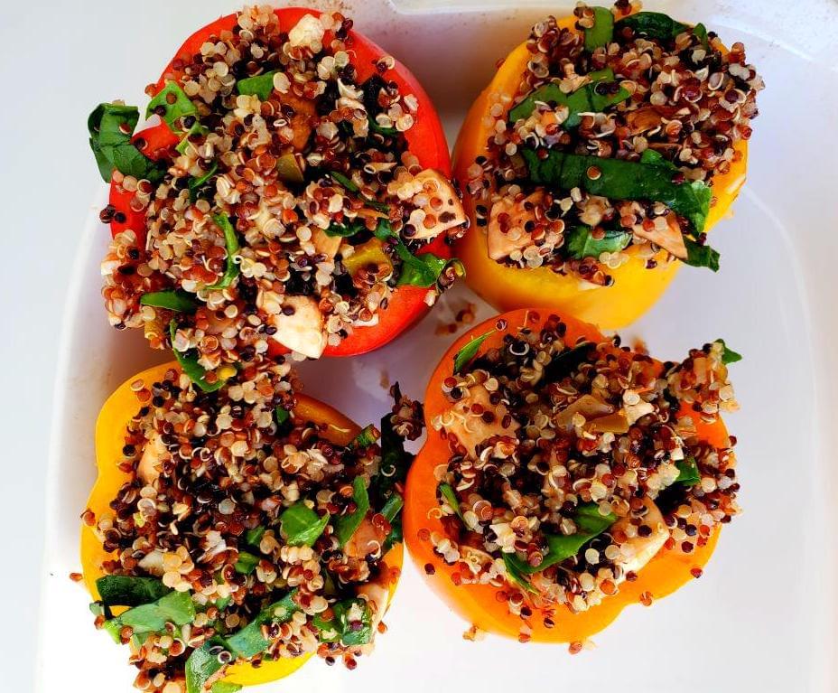 Uncooked quinoa and vegetable stuffed peppers