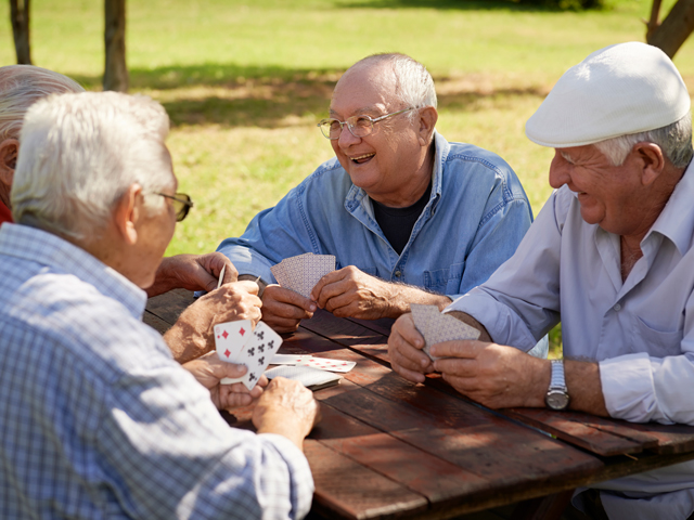 A group of four older people playing Asshole