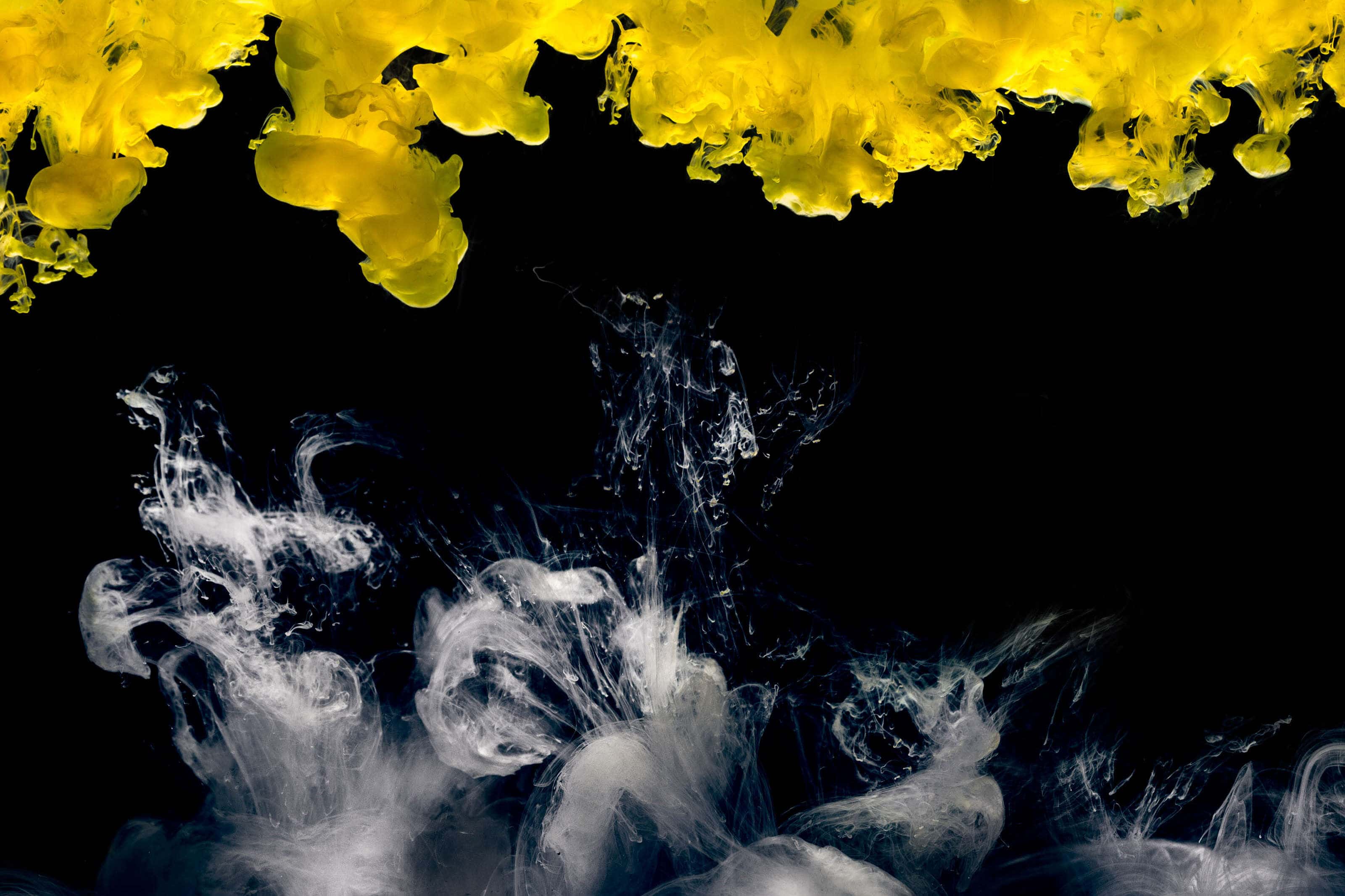 yellow and white clouds in black liquid