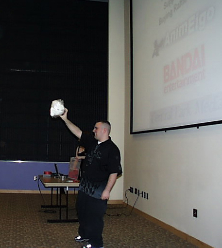 Sponsors being shown at a raffle. The names AnimEigo, Bandai entertainment, and an illegible name are show