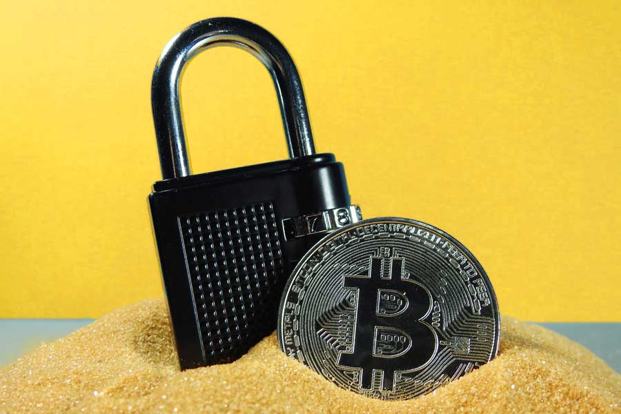 A padlock next to a coin with the Bitcoin symbol