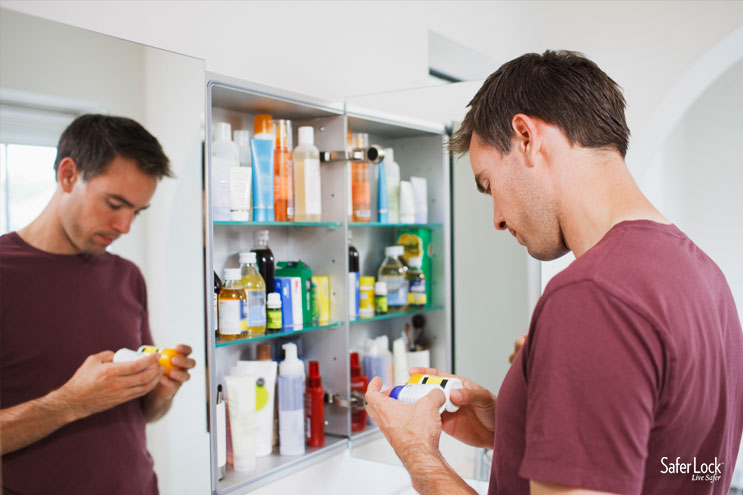 A man looks through the contents of a medicine cabinet.
