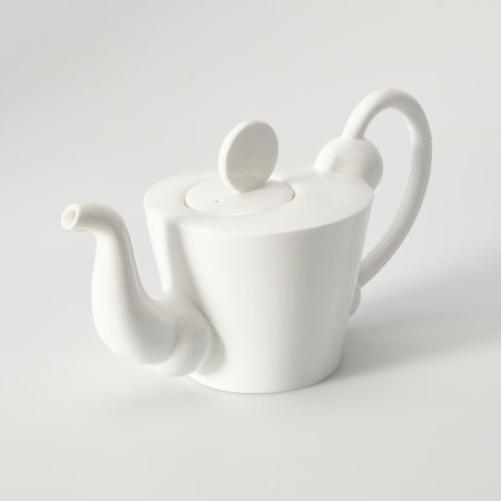 White teapot seen from a high angle, showing that the lid is offset and circular, with a flat disk set vertically upon it to act as the knob.