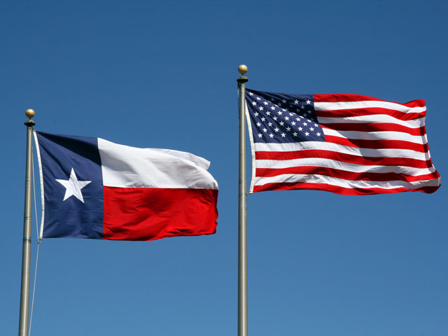 The United States Flag and Texas Flag flying high above a store where they sell beer in the state of Texas