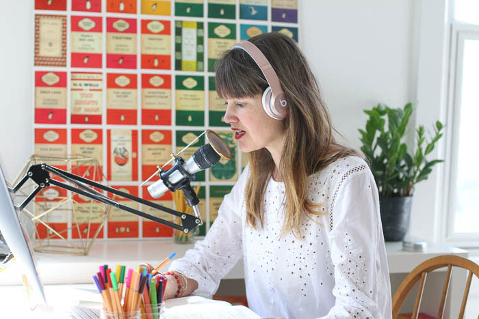 anne bogel wearing headphones and talking with a microphone