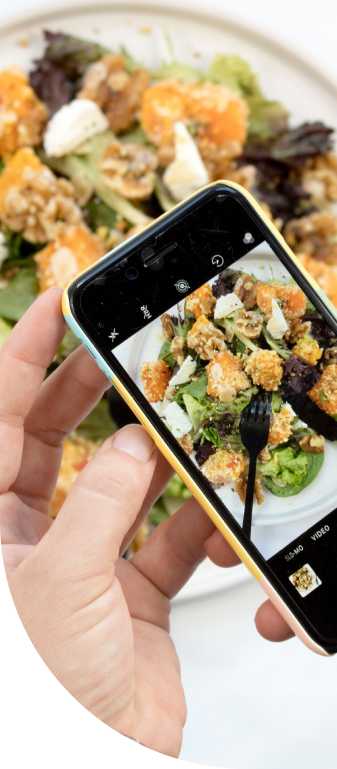 A photo of a phone, taking a picture of a meal on a dish. 