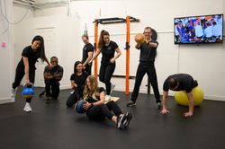 The whole Integral Physio team doing multiple workout activities in the newly-built on-site gym
