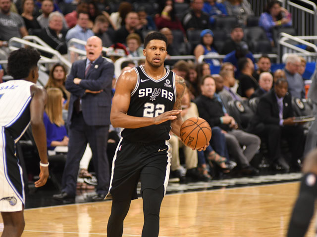 A San Antonio Spurs player dribbling up the court
