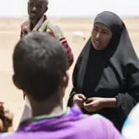 Woman talking to group of people