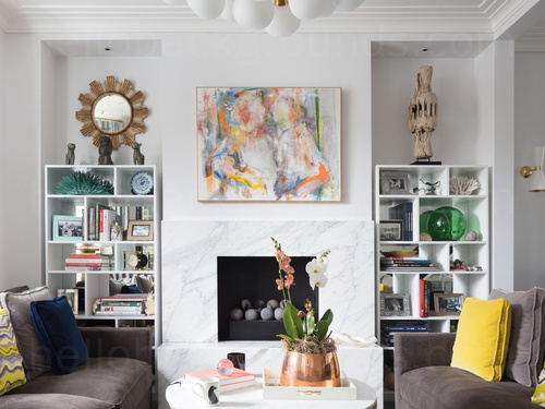 Contemporary living room featuring fireplace with bookcases on either side and two brown sofas Google Meet background