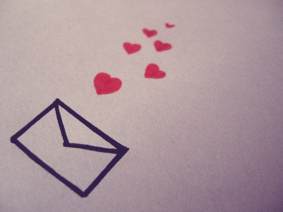 Love letter: red hearts flowing out of an envelope