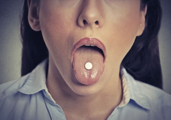 Woman taking an emergency contraceptive pill