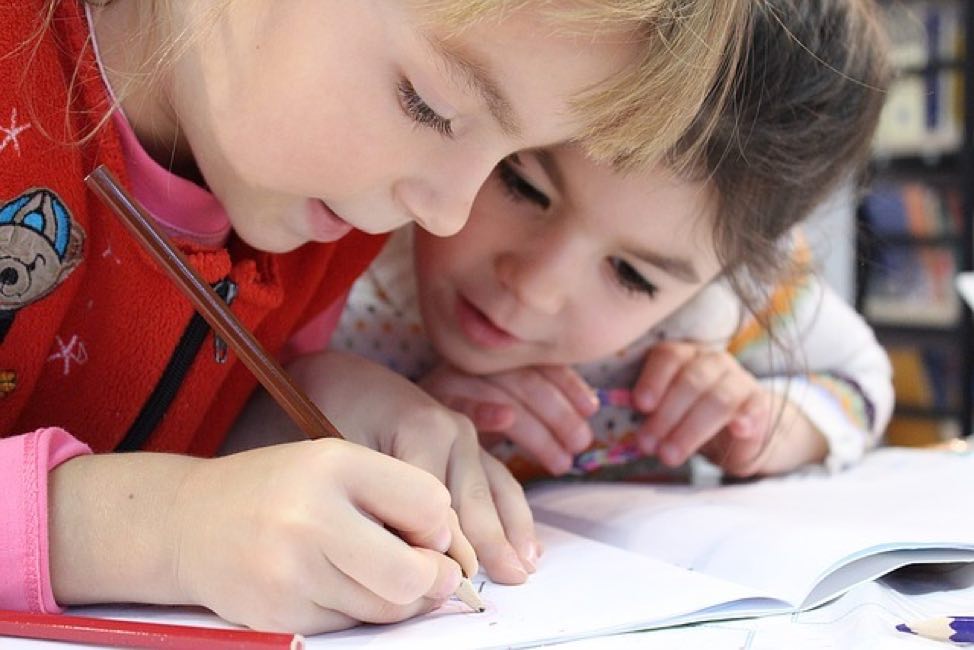 Children Drawing in a Notebook