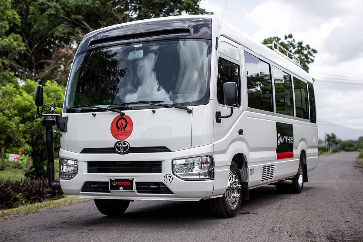 An Anywhere bus drives through the Costa Rican hillside