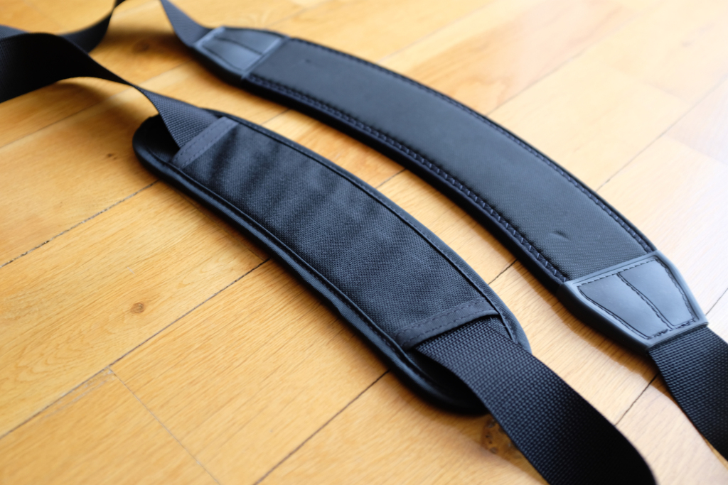 The Absoulute shoulder strap is larger and bigger, which makes it suitable for heavy loads and big bags.