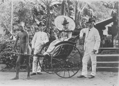A rickshaw puller and his passengers, 1900s