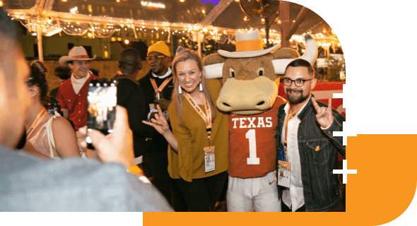 SXSW attendees taking a photo with the mascot Bevo