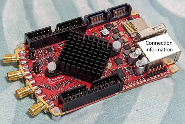 The Red Pitaya board seen from above. In the rear, a white sticker on the Ethernet port contains the connectino information for the board.